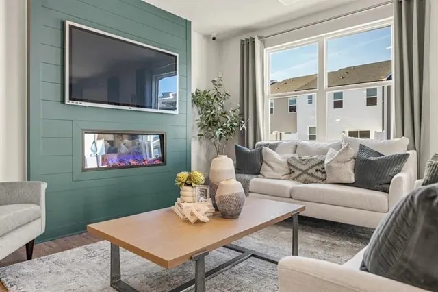 a living room with furniture and a large window