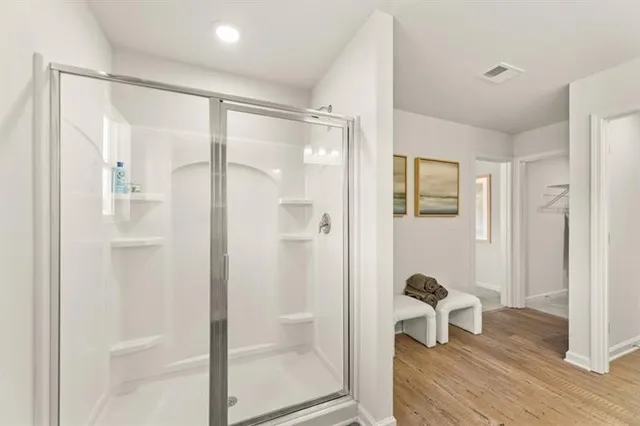 a bathroom with a glass shower door and a bathtub