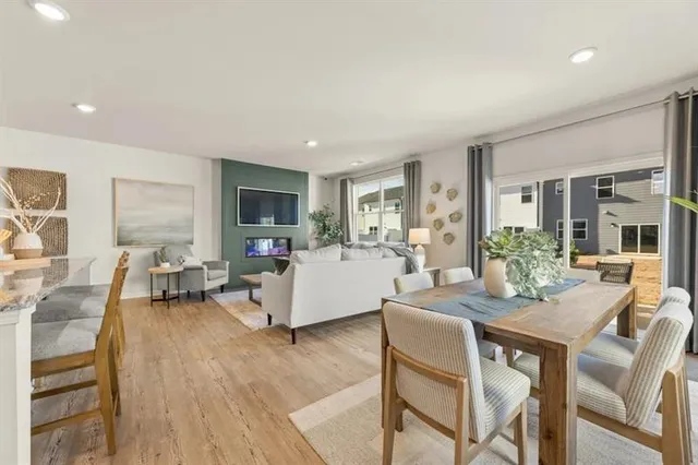 a living room with fireplace furniture and a wooden floor