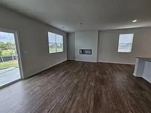 a view of room with window and wooden floor