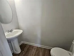 a bathroom with a sink toilet and a mirror