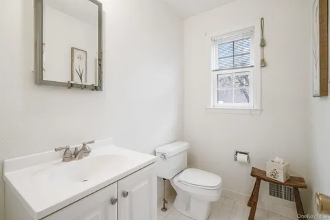 a white toilet sitting next to a bathroom sink