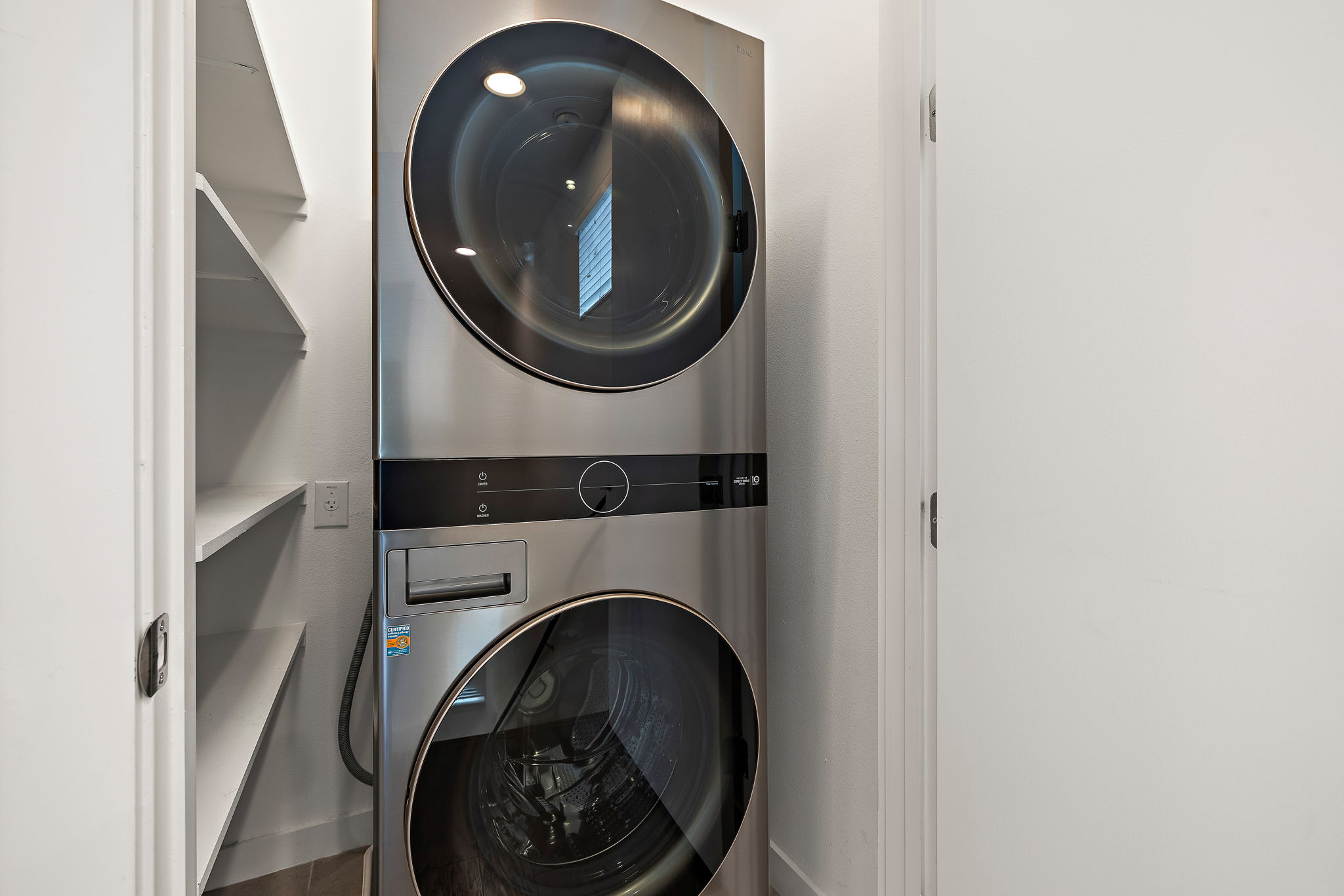 1206 Sarabeth Way Austin, TX 78721 - Photo 24 of 27 Washroom with stacked washer and dryer, baseboards, and laundry area