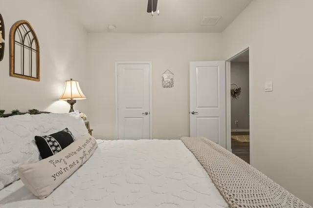 a bedroom with a bed a window and dresser