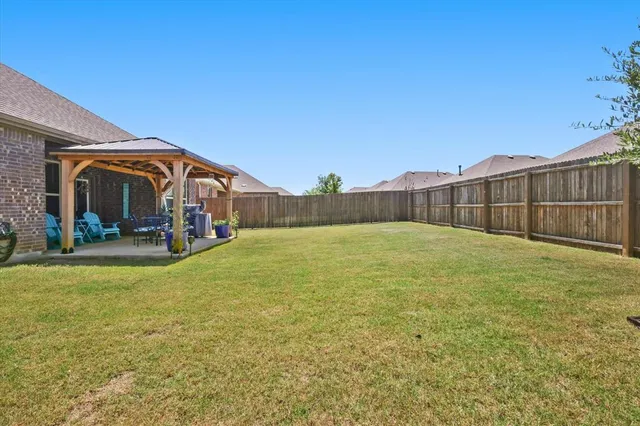 a view of a bedroom with furniture and floor to ceiling window