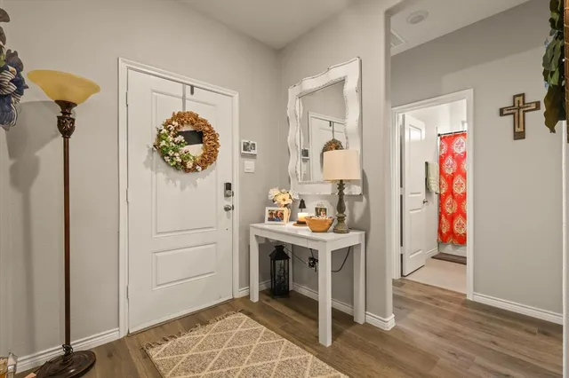 a view of hallway with furniture and wooden floor