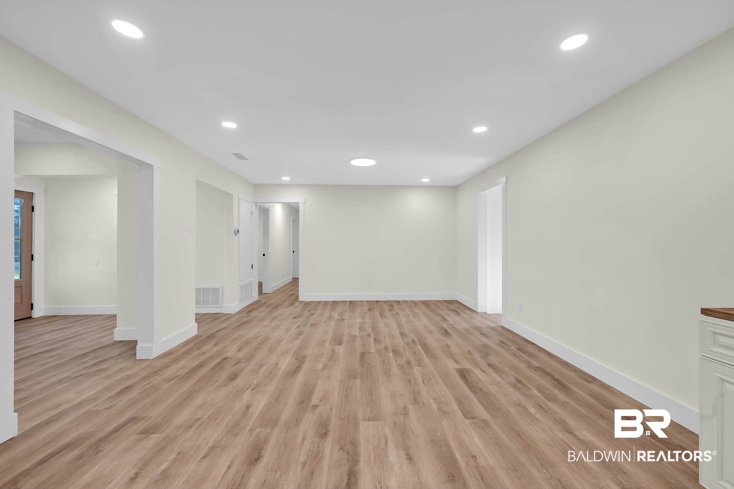 5109 McDonald Road Theodore, AL 36582 - Photo 10 of 21 Open-concept room featuring wood-finish flooring, recessed lighting, neutral wall tones, and white trim
