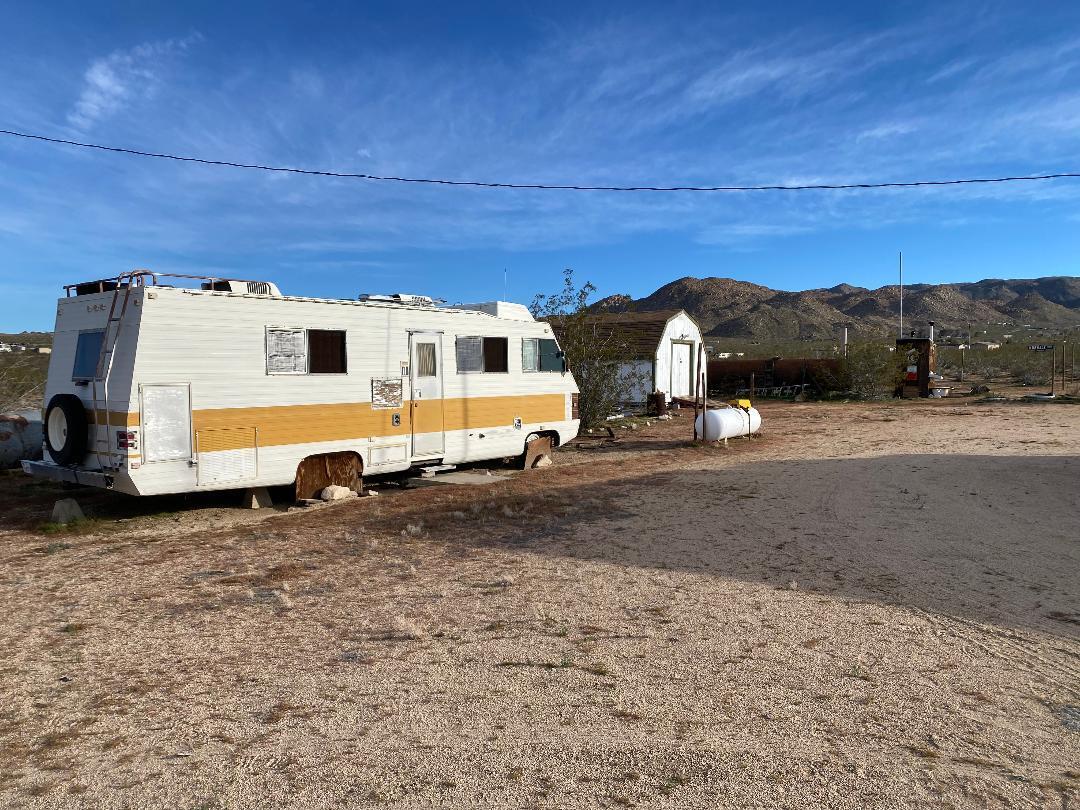 5457 Larrea Road Johnson Valley, CA 92285 - Photo 12 of 22 a view of a truck parked in front of a house