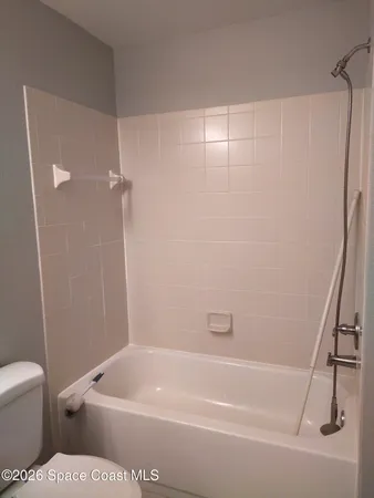 a bathroom with a bathtub and toilet