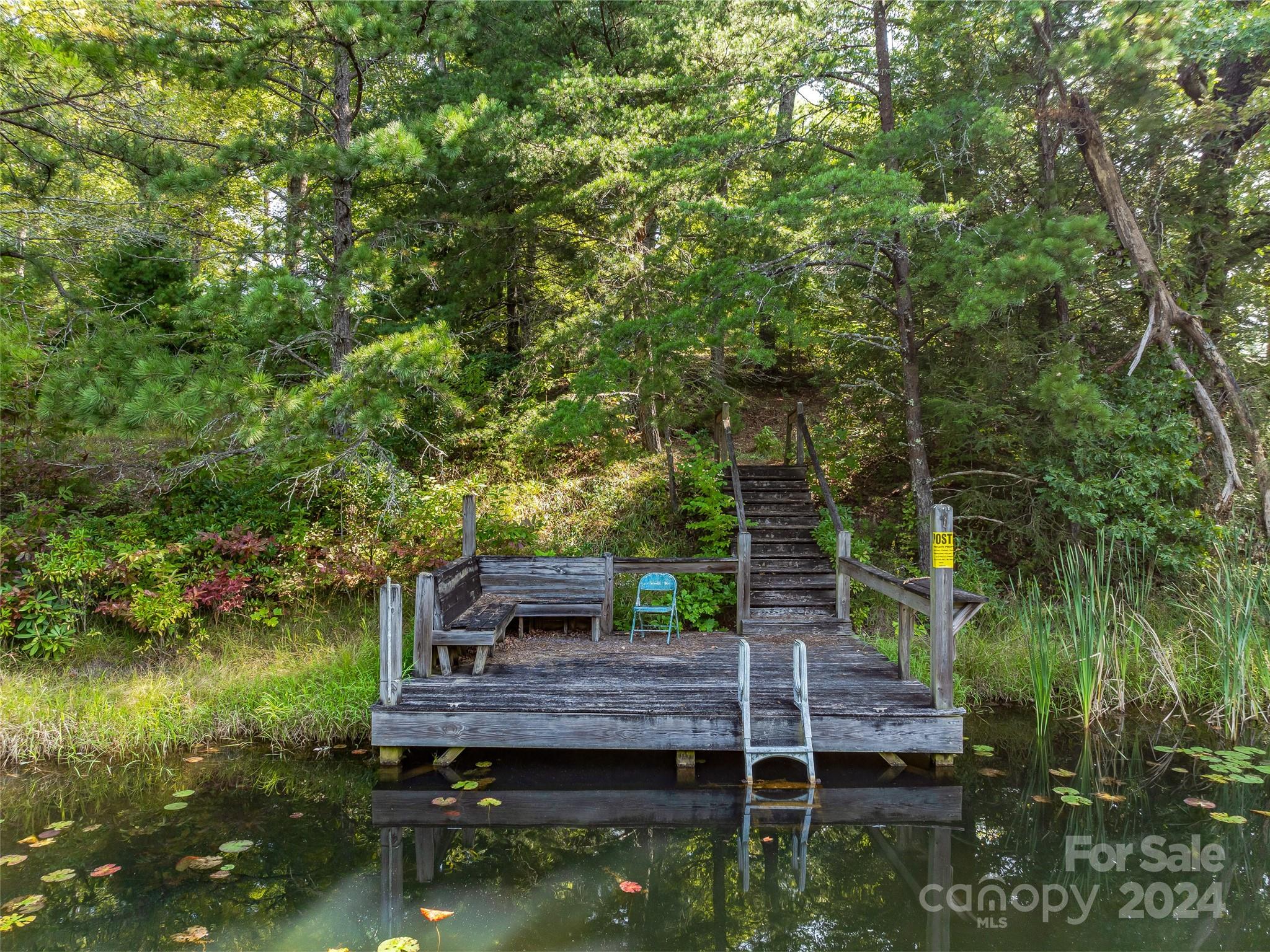567 Davey Branch Road Horse Shoe, NC 28742 - Photo 18 of 36 a wooden deck with trees in front of it