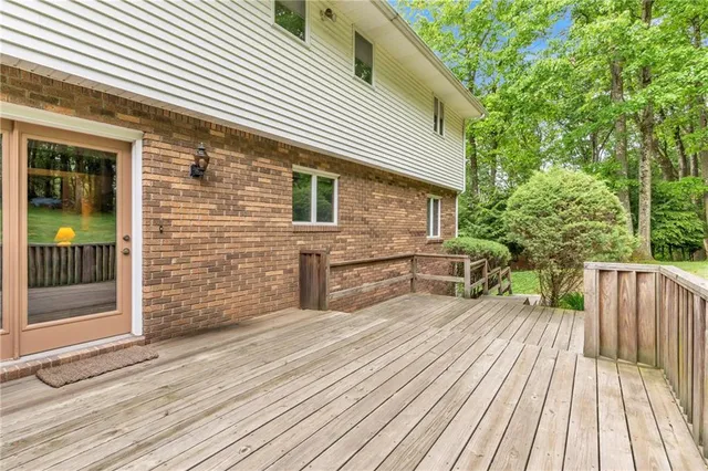 a view of backyard with deck and wooden floor