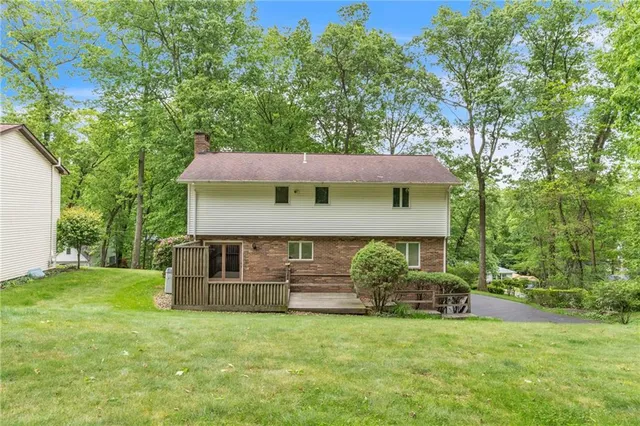 a view of a house with a yard and sitting area