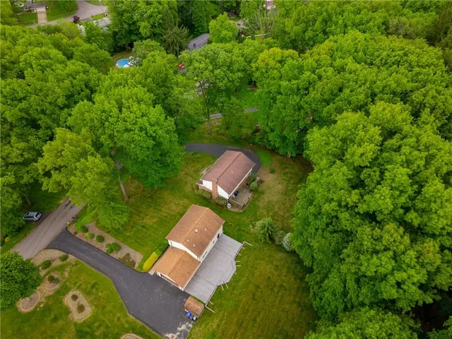 an aerial view of a house with a yard
