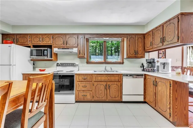 a kitchen with stainless steel appliances granite countertop a stove sink and cabinets
