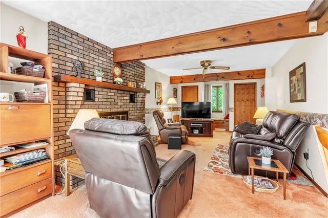 a living room with furniture a flat screen tv and a window