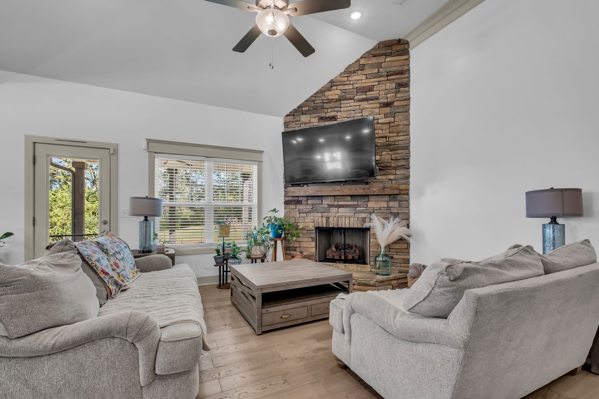 807 Ridgestone Place Lebanon, TN 37087 - Photo 8 of 34 a living room with furniture a flat screen tv and a fireplace