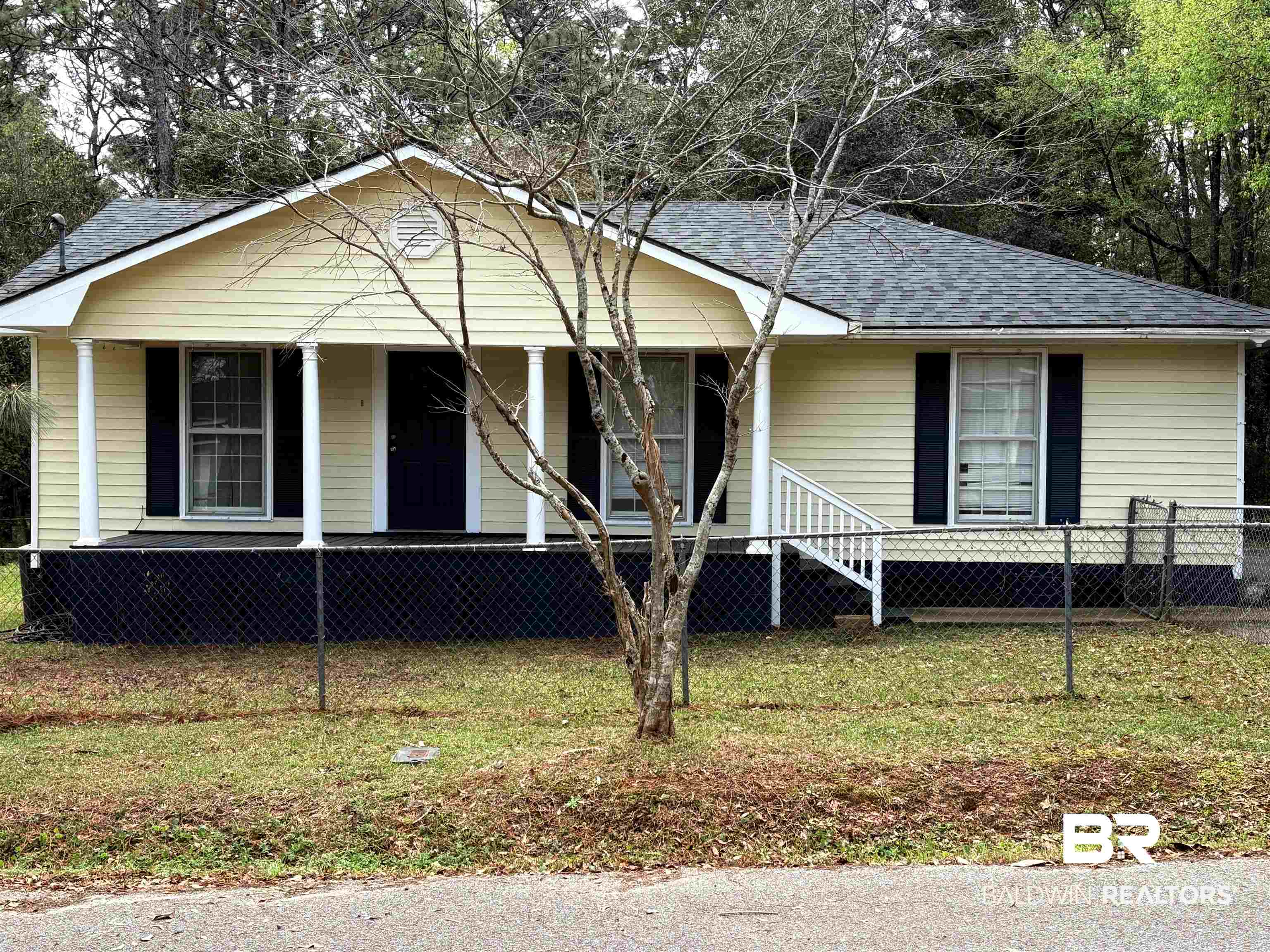 8065 Middle Ring Road Mobile, AL 36619 - Photo 2 of 21 View of front of property featuring a porch, a fenced front yard, and a shingled roof