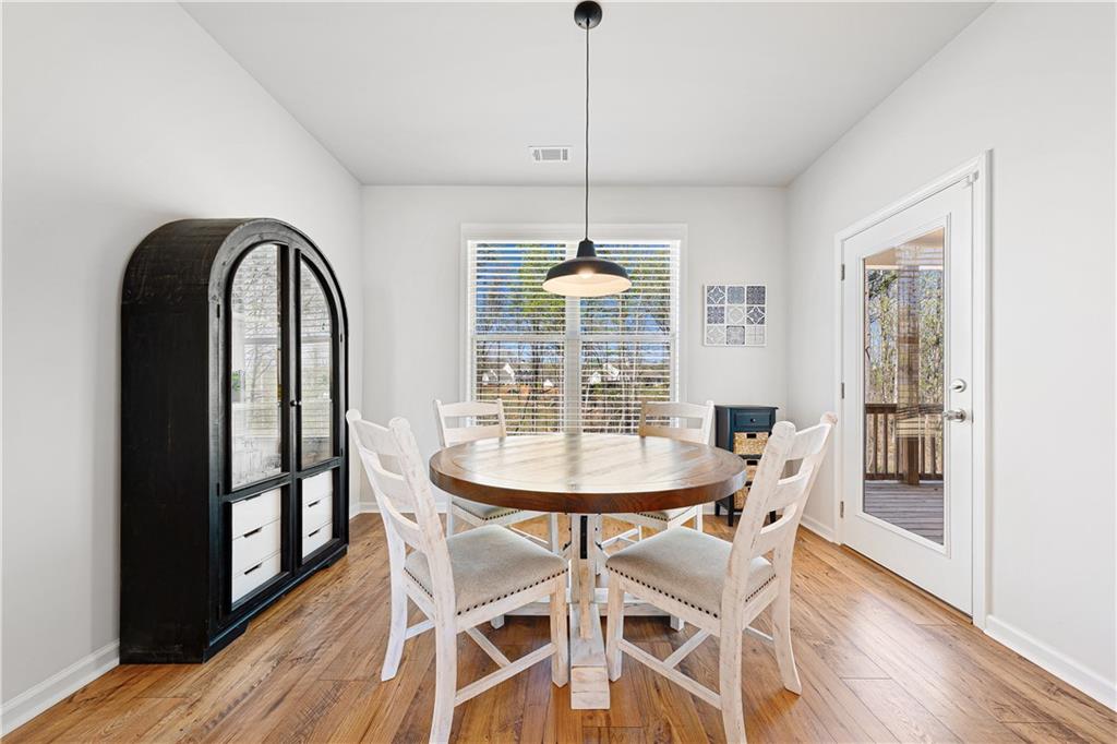 281 Greystone Court Winder, GA 30680 - Photo 20 of 71 a view of a dining room with furniture window and wooden floor