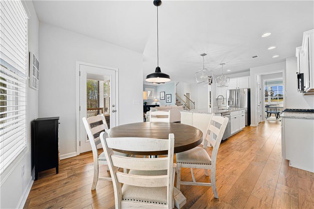 281 Greystone Court Winder, GA 30680 - Photo 21 of 71 a dining room with furniture and wooden floor