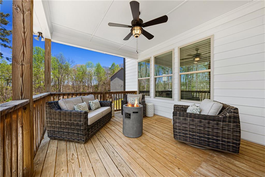 281 Greystone Court Winder, GA 30680 - Photo 23 of 71 a living room with couch a wooden floor and a potted plant