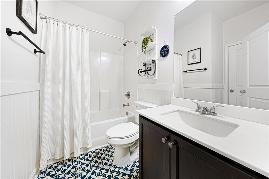 281 Greystone Court Winder, GA 30680 - Photo 26 of 71 a bathroom with a sink a toilet and shower curtain