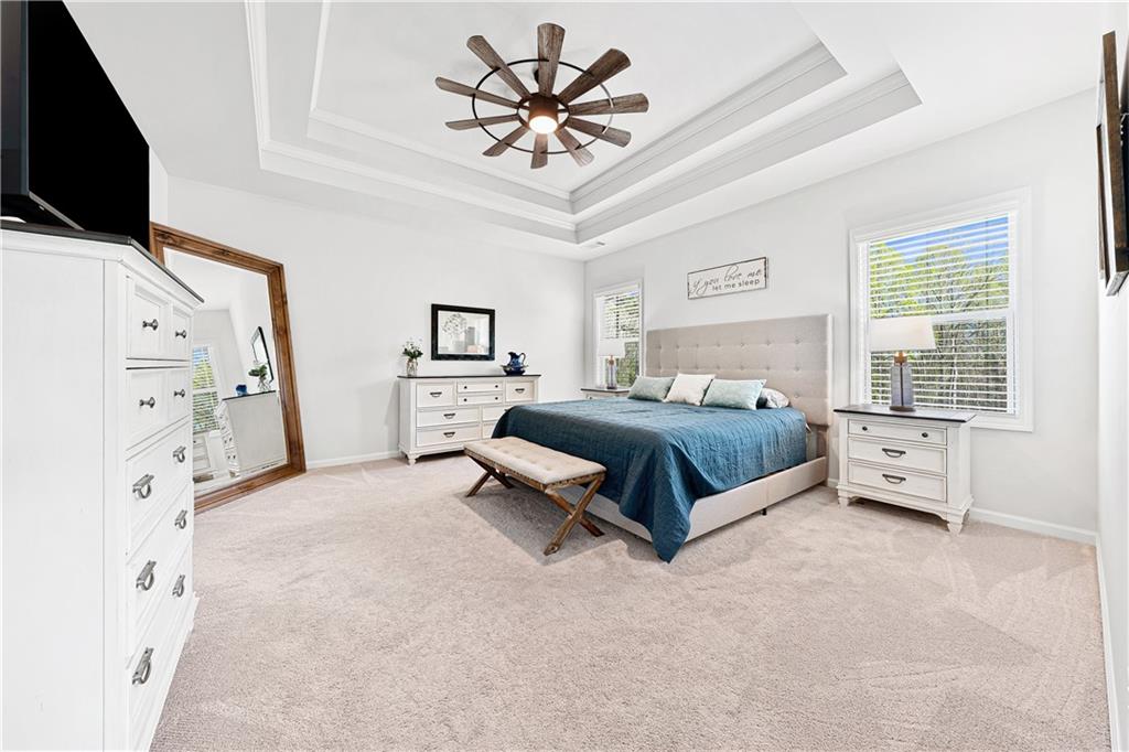 281 Greystone Court Winder, GA 30680 - Photo 29 of 71 a spacious bedroom with a bed and a flat screen tv