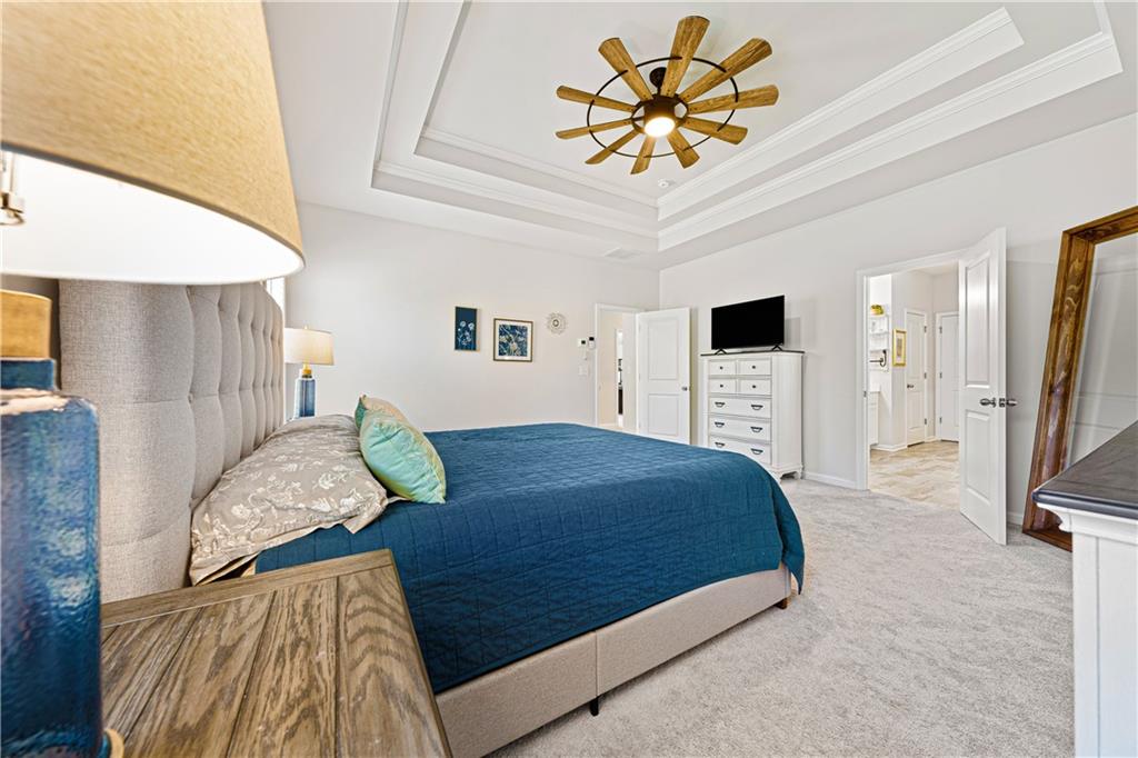 281 Greystone Court Winder, GA 30680 - Photo 30 of 71 a bedroom with a bed and a flat screen tv