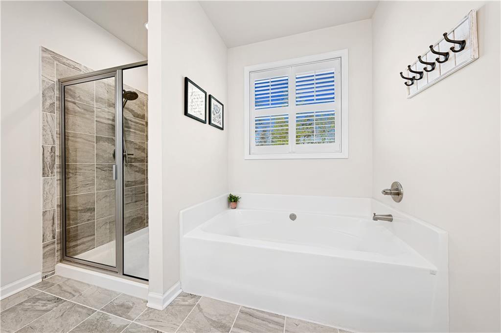 281 Greystone Court Winder, GA 30680 - Photo 33 of 71 a white bath tub sitting next to a shower