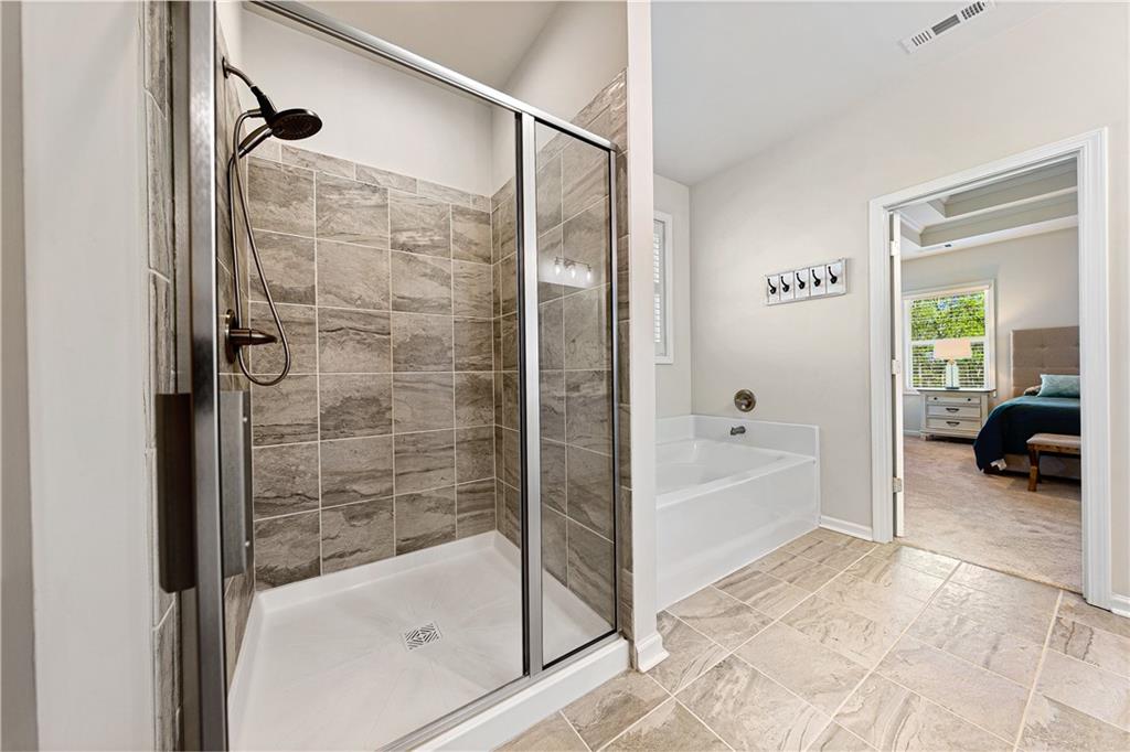 281 Greystone Court Winder, GA 30680 - Photo 34 of 71 a bathroom with a tub and shower