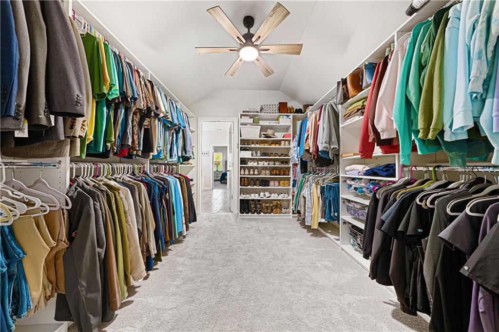 281 Greystone Court Winder, GA 30680 - Photo 35 of 71 a view of walk in closet with clothes and shoes