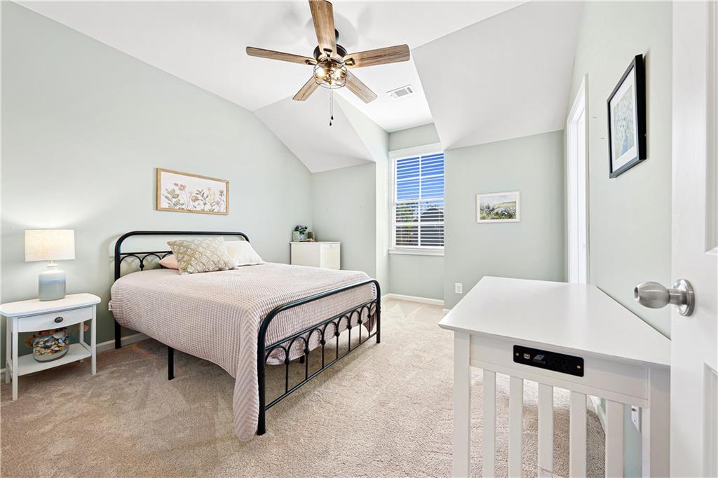 281 Greystone Court Winder, GA 30680 - Photo 36 of 71 a bedroom with a bed a window and a chandelier