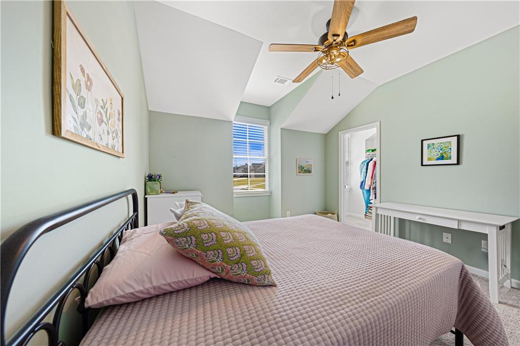 281 Greystone Court Winder, GA 30680 - Photo 37 of 71 a bedroom with a bed and a chandelier