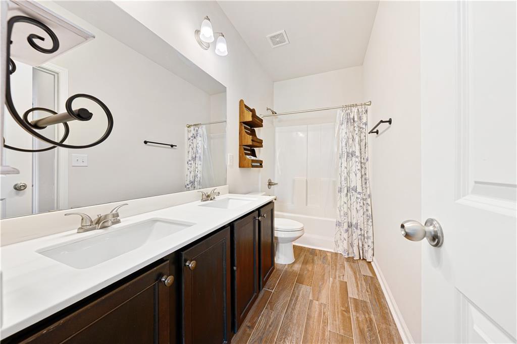 281 Greystone Court Winder, GA 30680 - Photo 38 of 71 a bathroom with a double vanity sink and a mirror