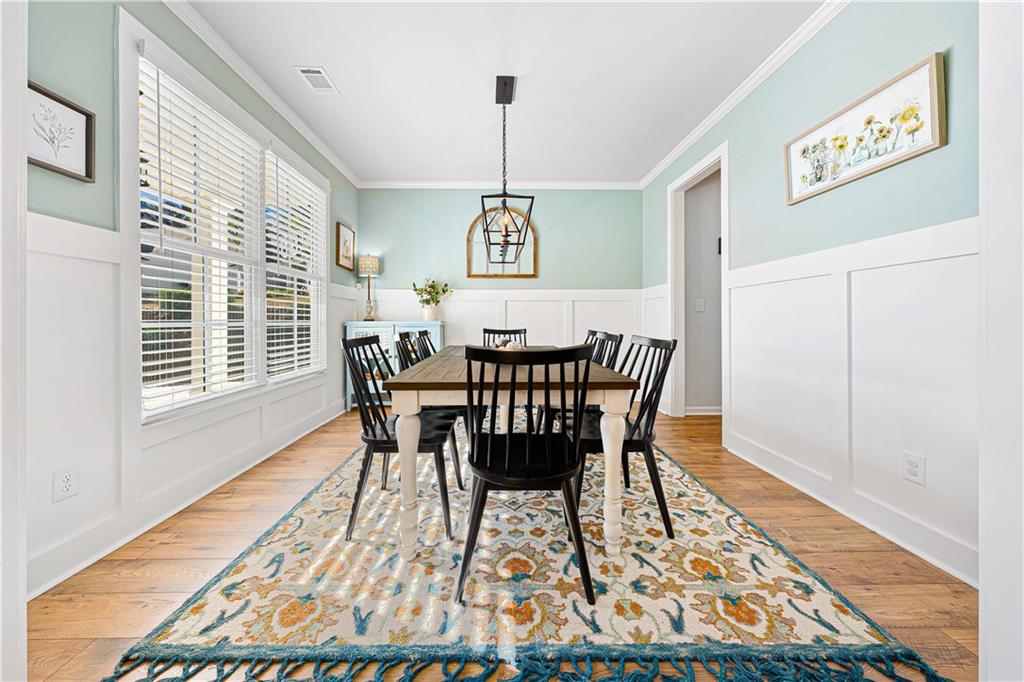 281 Greystone Court Winder, GA 30680 - Photo 8 of 71 a view of a dining room with furniture window and wooden floor