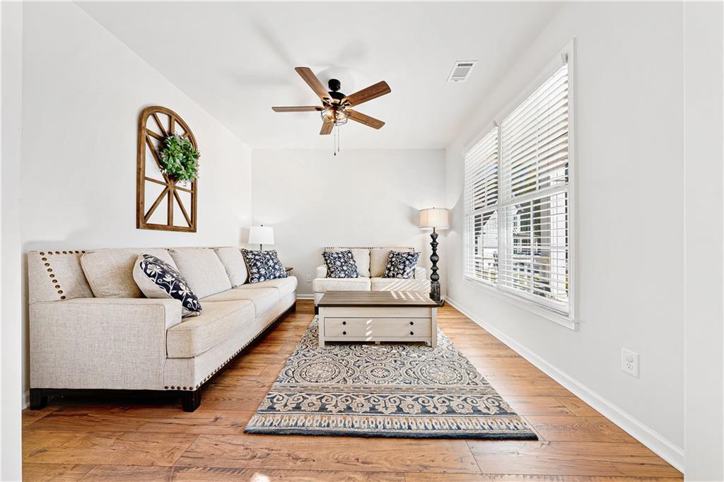 281 Greystone Court Winder, GA 30680 - Photo 10 of 71 a living room with a couch and a rug