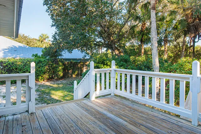 a view of balcony with wooden floor and fence