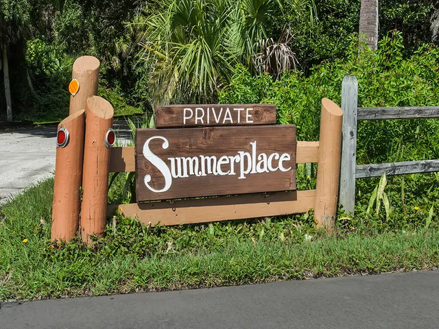 a sign board with a park bench