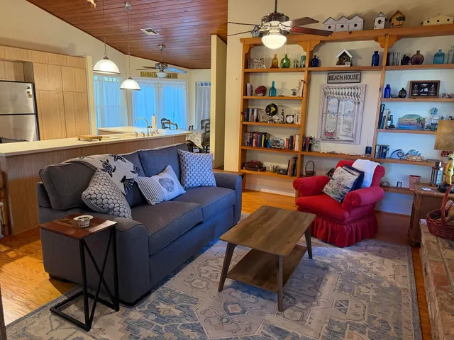 a living room with furniture a rug and white walls