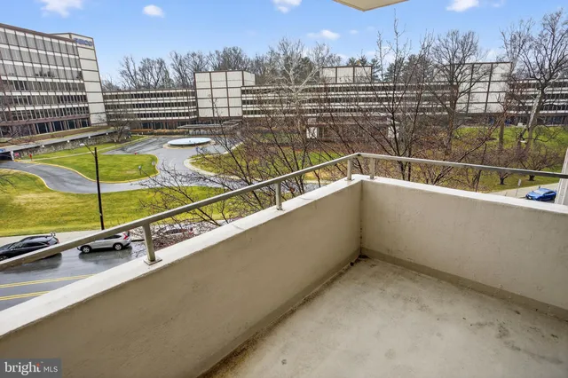 a view of swimming pool with outdoor seating and city view