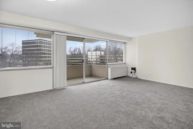 a view of an empty room with a fireplace