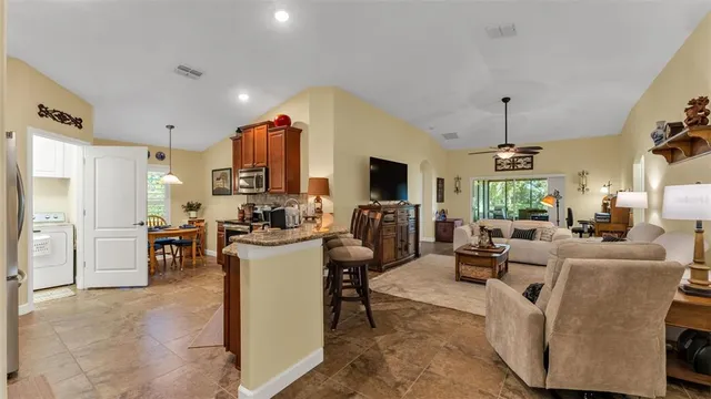 a kitchen with stainless steel appliances granite countertop sink stove top oven and cabinets