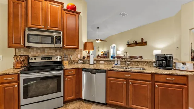 a bedroom with a bed and a flat tv screen on the dresser