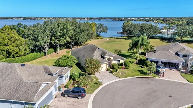 an aerial view of a house with a lake view