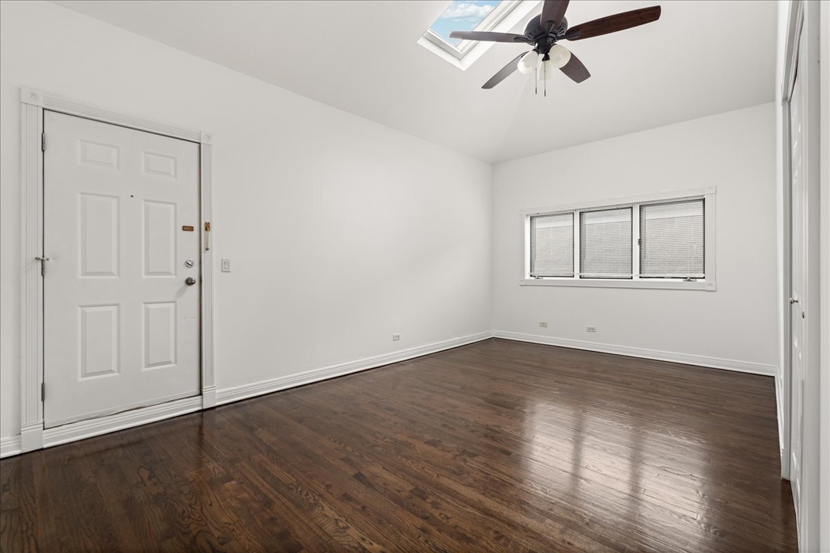 821 North Milwaukee Avenue, Unit 3 Chicago, IL 60642 - Photo 12 of 16 an empty room with wooden floor closet and windows
