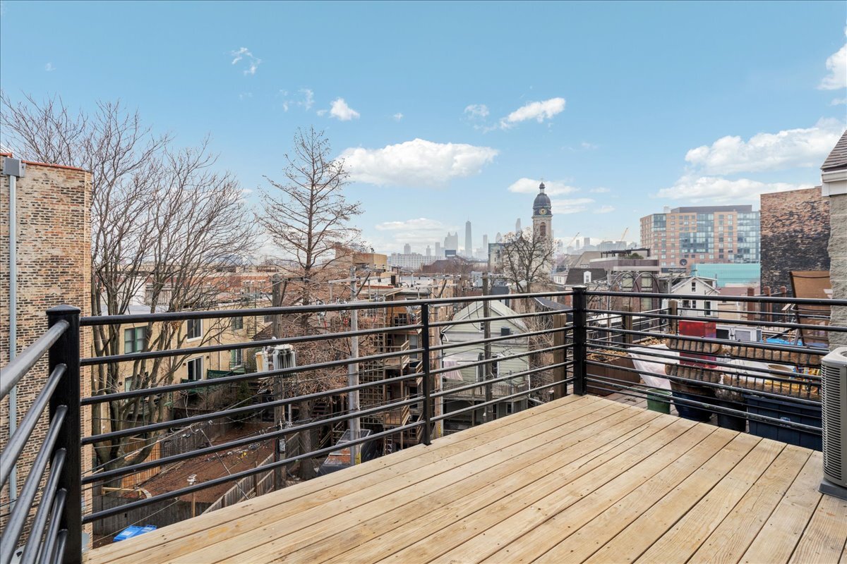 821 North Milwaukee Avenue, Unit 3 Chicago, IL 60642 - Photo 16 of 16 a view of a roof deck with wooden floor and fence