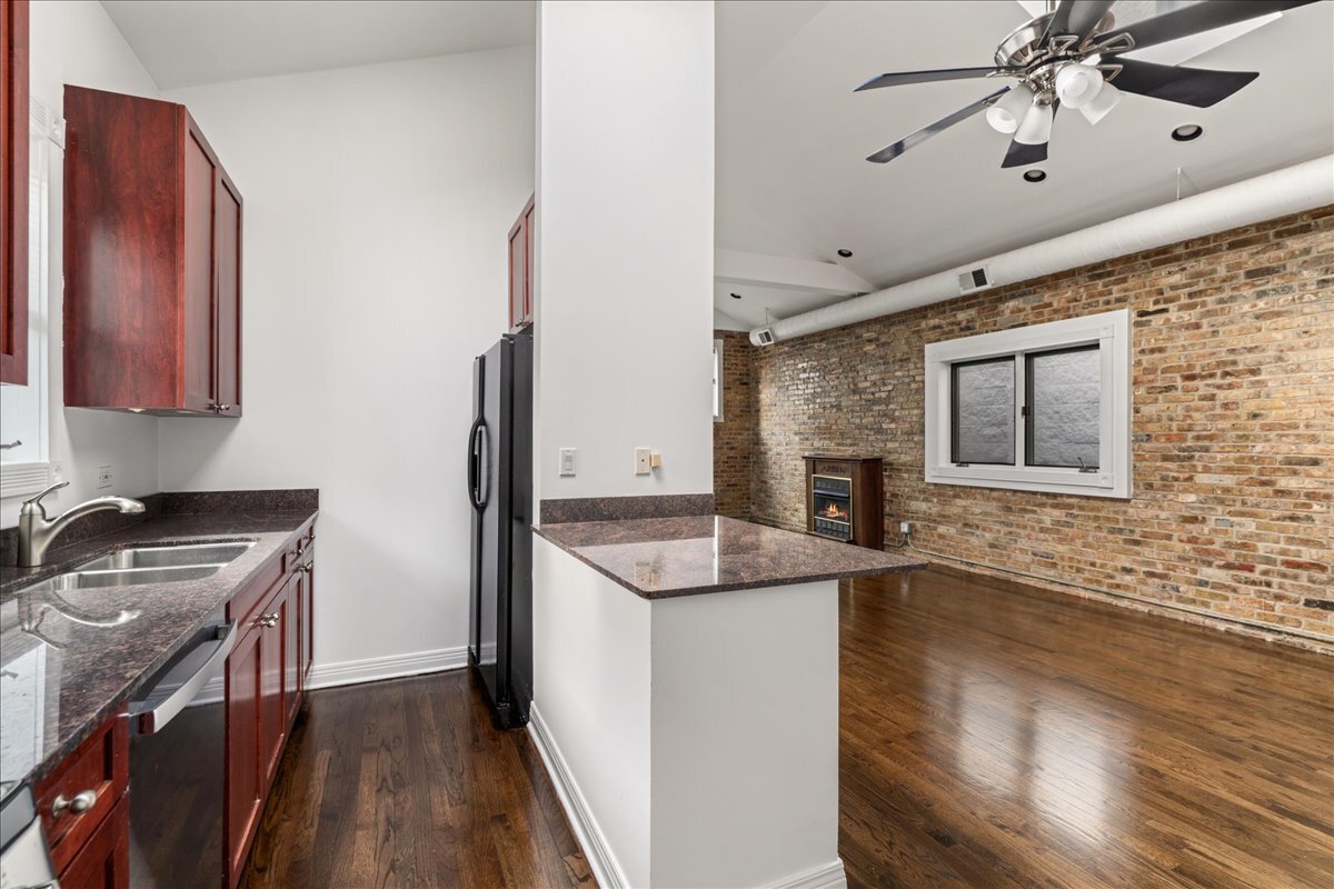 821 North Milwaukee Avenue, Unit 3 Chicago, IL 60642 - Photo 8 of 16 a kitchen with granite countertop a sink stainless steel appliances and cabinets