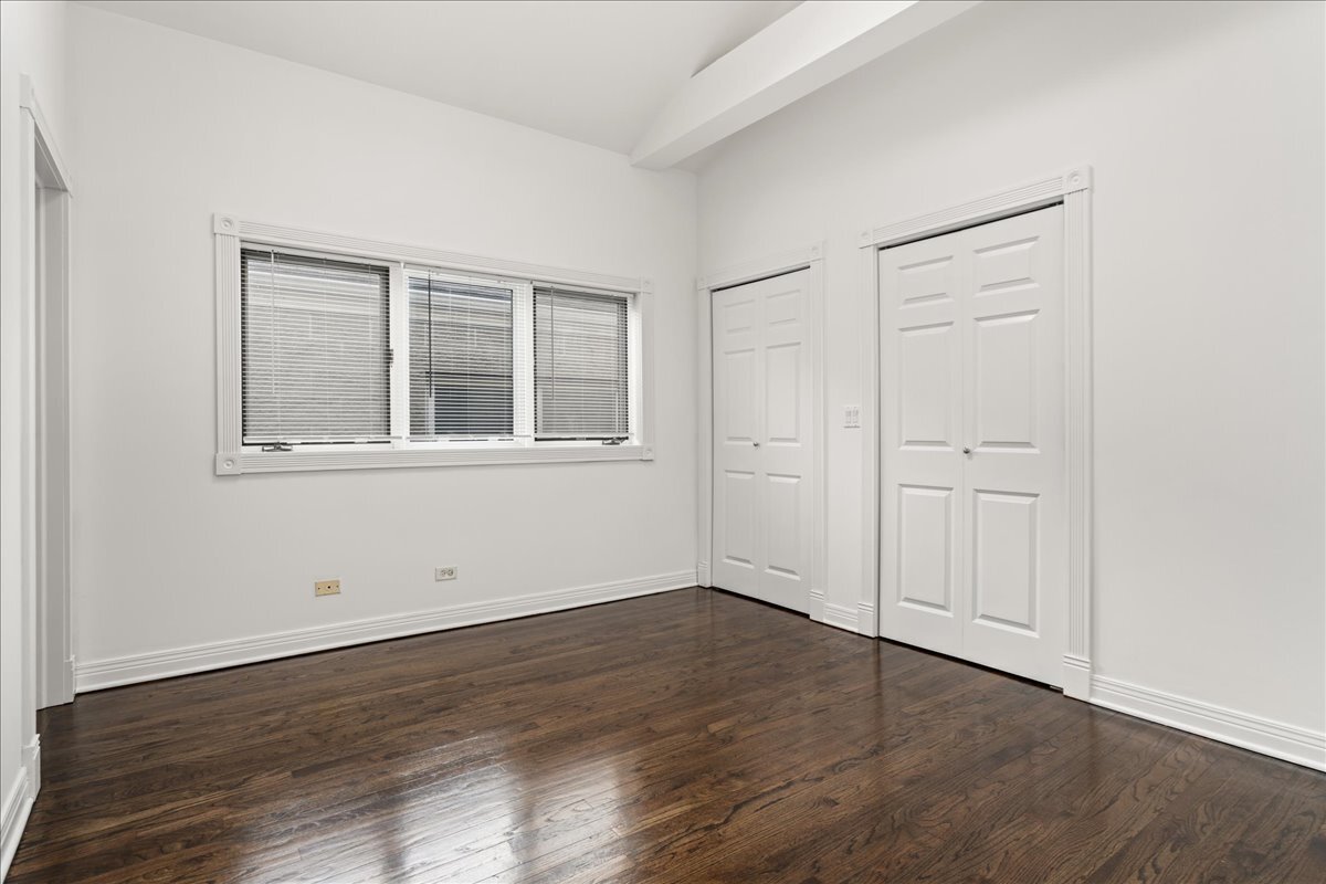 821 North Milwaukee Avenue, Unit 3 Chicago, IL 60642 - Photo 9 of 16 an empty room with wooden floor and windows