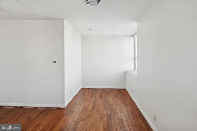 a view of a room with wooden floor