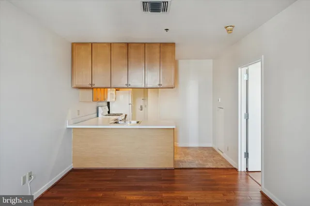 a view of a kitchen with sink and cabinets