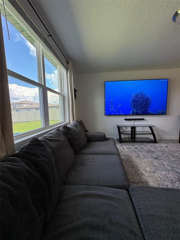 4836 Rigging Street Haines City, FL 33844 - Photo 12 of 29 a bed sitting in a bedroom next to a window